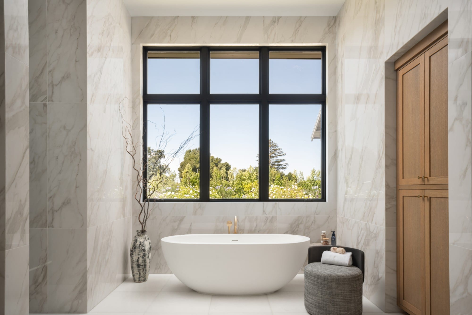 Freestanding bath in a marble bathroom, photographed by The Visaro